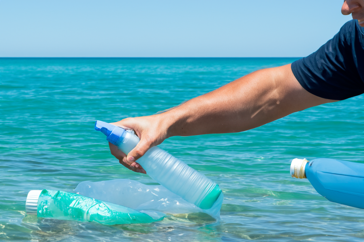 A person picking up plastic bottle from the ocean, emphasising Fresh Koala is a plastic free cleaning product.
